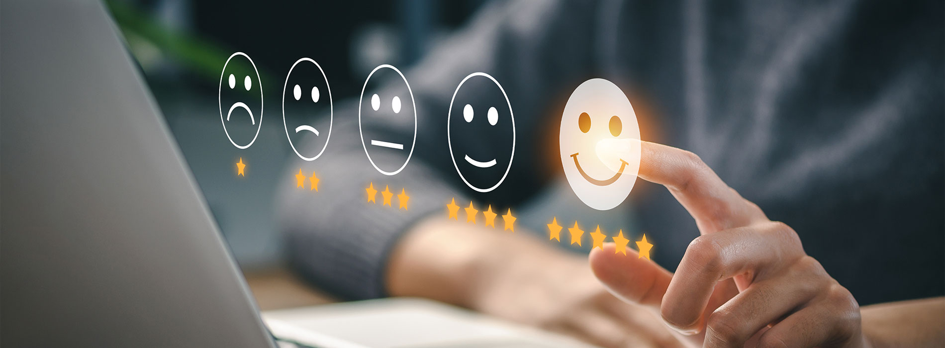 The image shows a person's hand operating a laptop with an emoji-filled interface, suggesting a digital communication or social media platform.