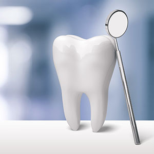 The image features a white dental model placed on a desk with a magnifying glass resting nearby, suggesting inspection or examination.