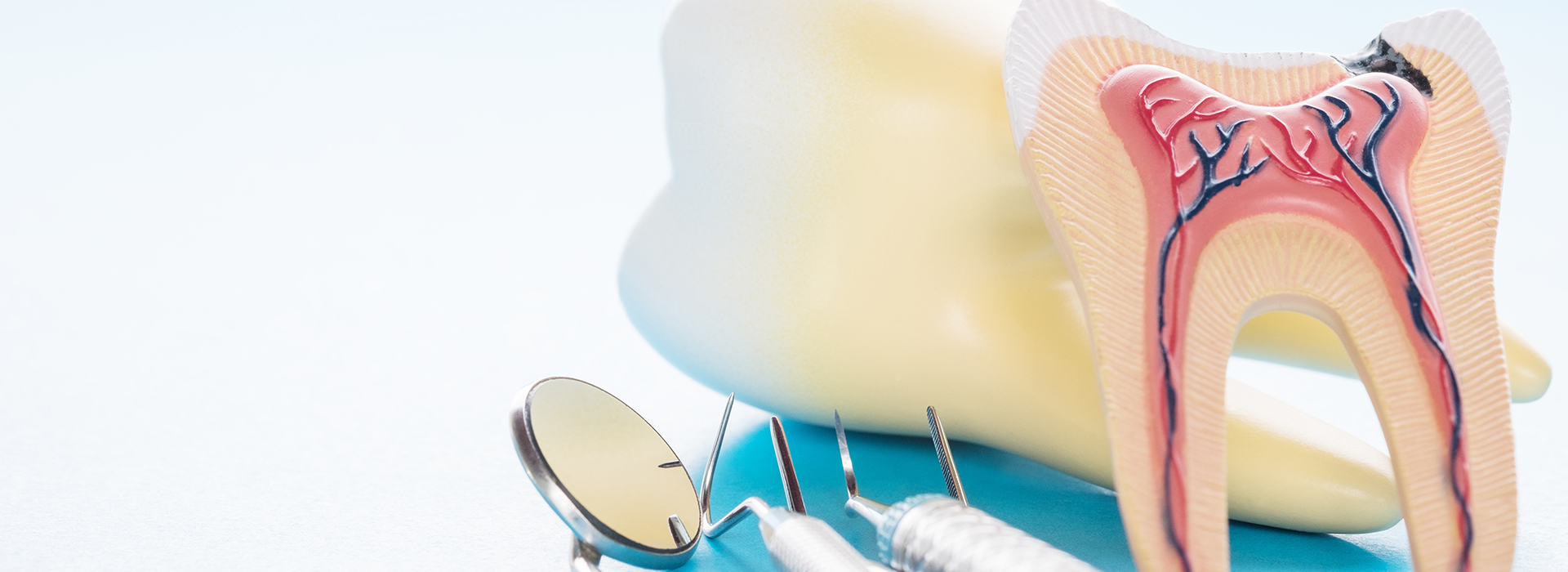 The image shows a toothbrush with toothpaste and a dental model featuring a cavity, displayed against a blue background.